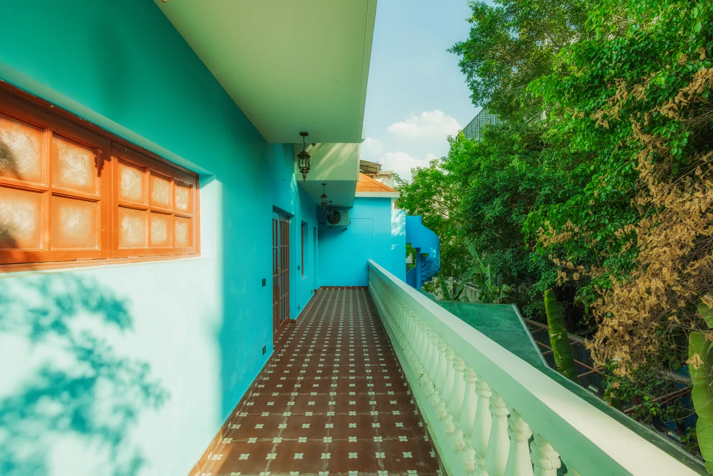 Turquoise balcony overlooking trees